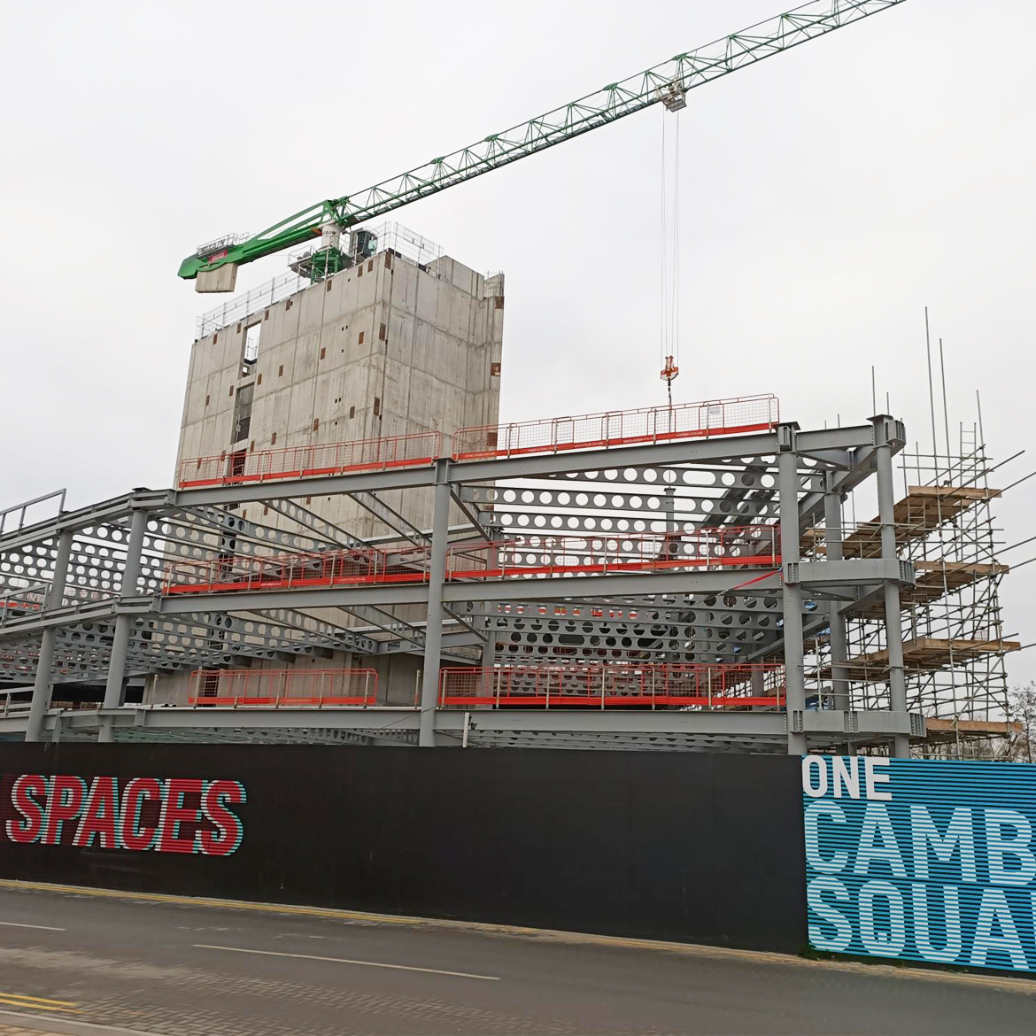 One Cambridge Square construction site with construction protection barriers and green crane and concrete tower